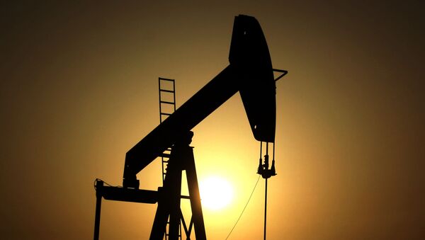 In this Wednesday, June 8, 2011 file photo, sun sets behind an oil pump in the desert oil fields - Sputnik International