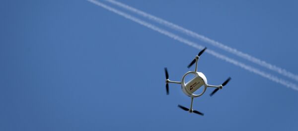 A drone carrying a mail box of Swiss Post flies past on July 7, 2015 above the airport of Bellechasse, western Switzerland A drone carrying a mail box of Swiss Post flies past on July 7, 2015 above the airport of Bellechasse, western Switzerland - Sputnik International