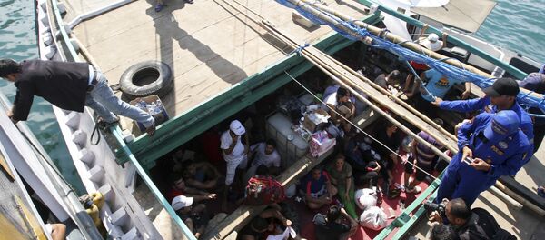 In this May 12, 2013 file photo, Iranian asylum seekers who were caught in Indonesian waters while sailing to Australia sit on a boat at Benoa port in Bali, Indonesia. Papua New Guinea's Supreme Court on Tuesday, April 26, 2016 ruled that Australia's detention of asylum seekers at a facility on the country's Manus Island is unconstitutional. In this May 12, 2013 file photo, Iranian asylum seekers who were caught in Indonesian waters while sailing to Australia sit on a boat at Benoa port in Bali, Indonesia. Papua New Guinea's Supreme Court on Tuesday, April 26, 2016 ruled that Australia's detention of asylum seekers at a facility on the country's Manus Island is unconstitutional. - Sputnik International