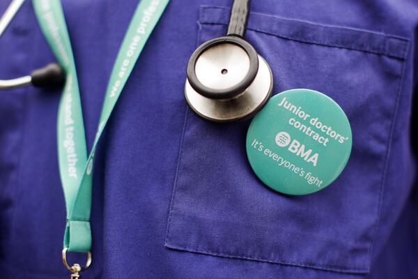 Junior doctors protest outside St Thomas' Hospital in central London on April 6, 2016, against proposed new conditions and pay rates for working unsociable hours. Junior doctors protest outside St Thomas' Hospital in central London on April 6, 2016, against proposed new conditions and pay rates for working unsociable hours. - Sputnik International