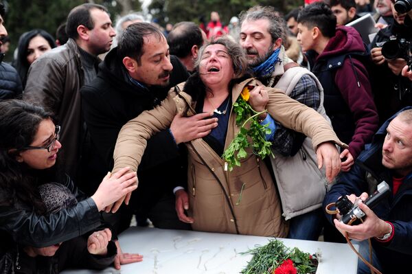 Berkin Elvan's mother Gulsum Elvan (C) grieves over her son's grave in Istanbul on March 7, 2015 as thousands of people marched to mark the first anniversary of the death of the youngest victim of the Gezi Park protests. Berkin Elvan's mother Gulsum Elvan (C) grieves over her son's grave in Istanbul on March 7, 2015 as thousands of people marched to mark the first anniversary of the death of the youngest victim of the Gezi Park protests. - Sputnik International