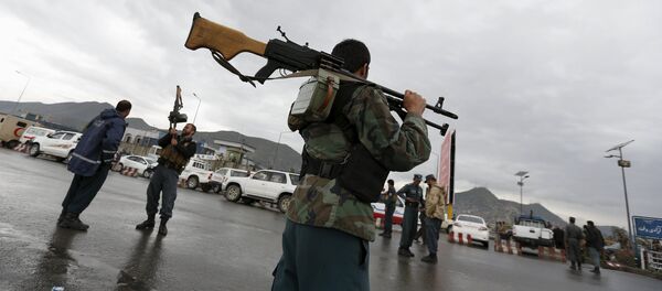 Afghan policemen stand guard at the site of a suicide car bomb attack on a government security building in Kabul, Afghanistan - Sputnik International