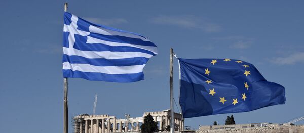 The Greek and EU flags flutter in front of the ancient Acropolis hill in Athens The Greek and EU flags flutter in front of the ancient Acropolis hill in Athens - Sputnik International