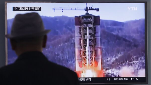 A man watches a TV news program showing a file footage of North Korea's rocket launch at Seoul Railway Station in Seoul, South Korea, Thursday, April 28, 2016. - Sputnik International