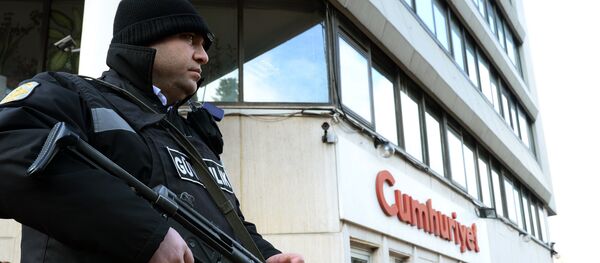 A police officer stands guard at the entrance of Cumhuriyet, the leading pro-secular Turkish newspaper, in Istanbul, Turkey A police officer stands guard at the entrance of Cumhuriyet, the leading pro-secular Turkish newspaper, in Istanbul, Turkey - Sputnik International