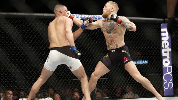 Nate Diaz, left, trades punches with Conor McGregor during their UFC 196 welterweight mixed martial arts match, Saturday, March 5, 2016, in Las Vegas - Sputnik International