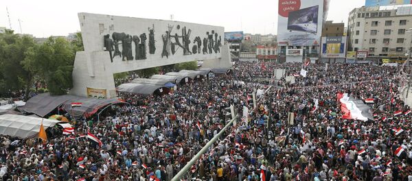 Followers of Iraq's Shi'ite cleric Moqtada al-Sadr gather and chant slogans during a protest demanding that parliament approves a long-delayed new cabinet and end political and sectarian wrangling that is hampering a vote on the matter, at Tahrir Square in Baghdad April 26, 2016 Followers of Iraq's Shi'ite cleric Moqtada al-Sadr gather and chant slogans during a protest demanding that parliament approves a long-delayed new cabinet and end political and sectarian wrangling that is hampering a vote on the matter, at Tahrir Square in Baghdad April 26, 2016 - Sputnik International