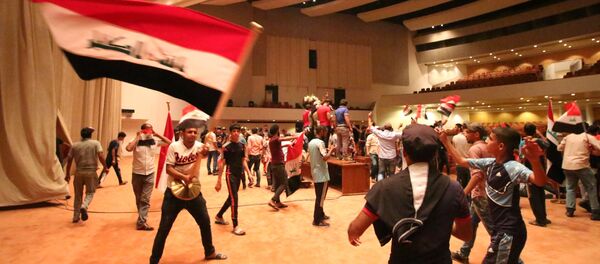 Iraqi protesters wave national flags as they gather inside the parliament after breaking into Baghdad's heavily fortified Green Zone on April 30, 2016 Iraqi protesters wave national flags as they gather inside the parliament after breaking into Baghdad's heavily fortified Green Zone on April 30, 2016 - Sputnik International