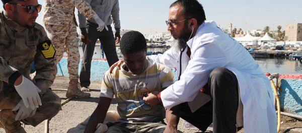 Migrants receive medical treatment in a port, after being rescued at sea by Libyan coast guard, in Tripoli, Libya April 11, 2016 Migrants receive medical treatment in a port, after being rescued at sea by Libyan coast guard, in Tripoli, Libya April 11, 2016 - Sputnik International