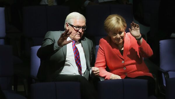 German Chancellor Angela Merkel, right, and Foreign Minister Frank-Walter Steinmeier wave as they attend a meeting of the German Federal Parliament, Bundestag, at the Reichstag building in Berlin, Germany, Thursday, Sept. 24, 2015 - Sputnik International