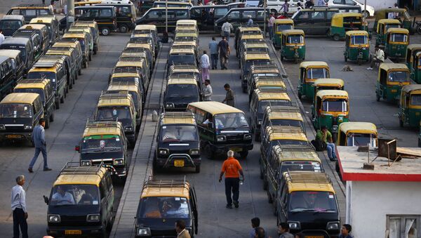 In this Monday, March 24, 2014 photo, traditional black-and-yellow licensed cabs stand parked waiting for customers at a railway station in New Delhi, India - Sputnik International