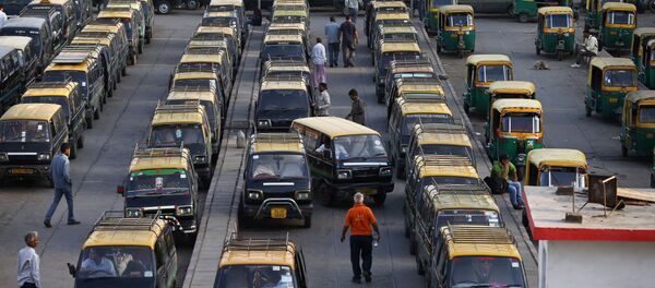In this Monday, March 24, 2014 photo, traditional black-and-yellow licensed cabs stand parked waiting for customers at a railway station in New Delhi, India In this Monday, March 24, 2014 photo, traditional black-and-yellow licensed cabs stand parked waiting for customers at a railway station in New Delhi, India - Sputnik International