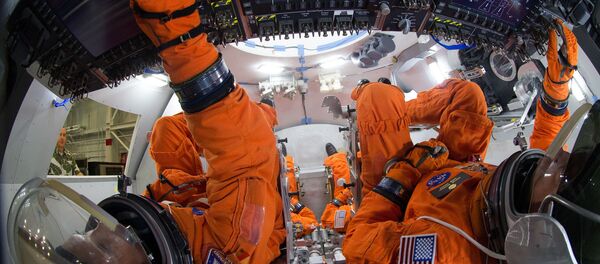 Spacesuit engineers demonstrate how four crew members would be arranged for launch inside the Orion spacecraft, using a mockup of the vehicle at Johnson Space Center. Astronauts will board Orion for a first crewed flight in 2021, and NASA hopes send humans to Mars in Orion in the 2030s Spacesuit engineers demonstrate how four crew members would be arranged for launch inside the Orion spacecraft, using a mockup of the vehicle at Johnson Space Center. Astronauts will board Orion for a first crewed flight in 2021, and NASA hopes send humans to Mars in Orion in the 2030s - Sputnik International