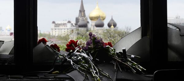 Flowers on a broken window in memory of the people killed by fire in the Trade Unions House on Odessa's Kulikovo Field Square. File photo Flowers on a broken window in memory of the people killed by fire in the Trade Unions House on Odessa's Kulikovo Field Square. File photo - Sputnik International
