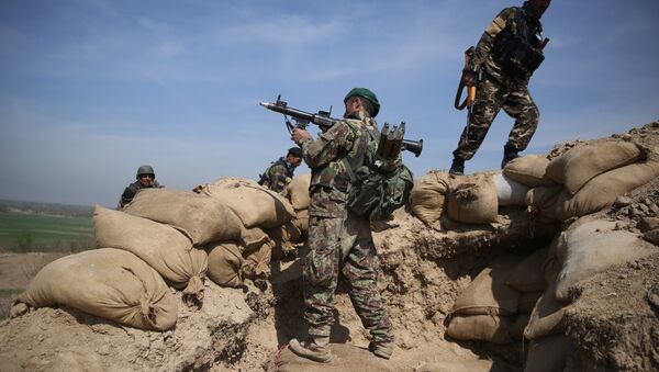 An Afghan National Army soldier, center, takes his position, following weeks of heavy clashes to recapture the area from Taliban militants in Dand-e Ghouri district in Baghlan province, north of Kabul, Afghanistan (File) - Sputnik International
