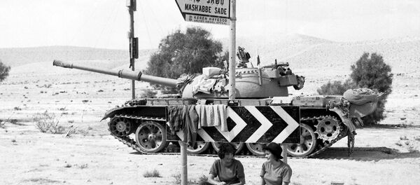 Two Israeli Army girls sit beneath a road sign, with a tank in the background, somewhere in the Sinai Desert, Oct. 8, 1973 Two Israeli Army girls sit beneath a road sign, with a tank in the background, somewhere in the Sinai Desert, Oct. 8, 1973 - Sputnik International