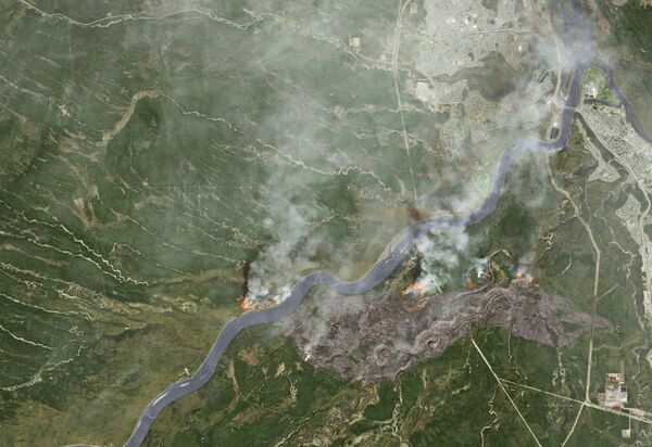 Smoke from wildfires near Fort McMurray, Alberta, Canada are shown in this satellite photo from NASA taken May 3, 2016. - Sputnik International