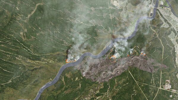 Smoke from wildfires near Fort McMurray, Alberta, Canada are shown in this satellite photo from NASA taken May 3, 2016. - Sputnik International