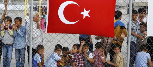 An elderly refugee man stands with children as they wait for the arrival of German Chancellor Angela Merkel, Turkish Prime Minister Ahmet Davutoglu, EU Council President Donald Tusk and European Commission Vice-President Frans Timmermans (all not pictured) at Nizip refugee camp near Gaziantep, Turkey, April 23, 2016.s - Sputnik International