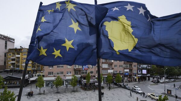 Kosovar Albanians walk under the EU and Kosovo flags in the main square of Pristina on May 4, 2016 - Sputnik International