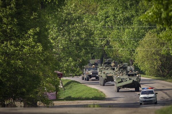 US military vehicles drive on a road in Sculeni, Moldova, Tuesday, May 3, 2016, as some 200 U.S. soldiers arrived in the country for more than two weeks of exercises, in a show of U.S. strength in the region US military vehicles drive on a road in Sculeni, Moldova, Tuesday, May 3, 2016, as some 200 U.S. soldiers arrived in the country for more than two weeks of exercises, in a show of U.S. strength in the region - Sputnik International