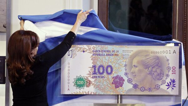 FILE - In this July 25, 2012 photo, Argentina's President Cristina Fernandez unveils an archetype of the new 100 Argentine pesos bill bearing the profile of former late first lady Maria Eva Duarte de Peron, better known as Evita, at the government palace in Buenos Aires, Argentina - Sputnik International