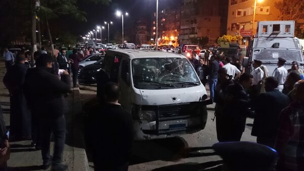 Egyptian police and civilians gather around a bullet ridden microbus in the south Cairo neighborhood of Helwan, Sunday, May 8, 2016 - Sputnik International