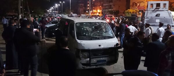 Egyptian police and civilians gather around a bullet ridden microbus in the south Cairo neighborhood of Helwan, Sunday, May 8, 2016 - Sputnik International