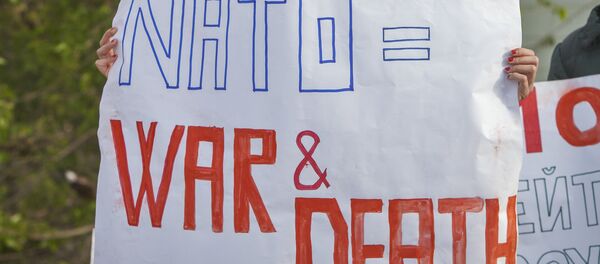 Moldovan youngsters hold anti-NATO banners during a protest staged by Moldova’s opposition in the border town of Sculeni, Moldova, Tuesday, May 3, 2016 against the May 3-20 joint US-Moldovan military exercises as less than 20 percent of Moldovans want to join the military alliance Moldovan youngsters hold anti-NATO banners during a protest staged by Moldova’s opposition in the border town of Sculeni, Moldova, Tuesday, May 3, 2016 against the May 3-20 joint US-Moldovan military exercises as less than 20 percent of Moldovans want to join the military alliance - Sputnik International