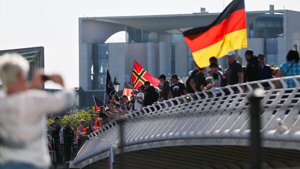 Right-wing protestors demonstrate against refugees, Islam and German Chancellor Angela Merkel in front of the chancellery in Berlin, Germany, May 7, 2016 - Sputnik International