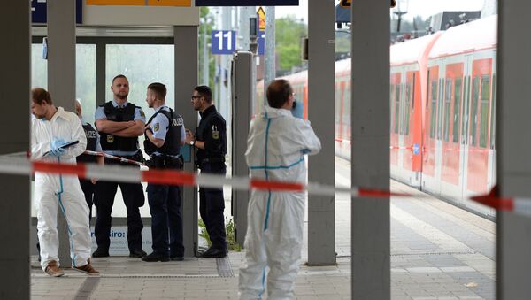 Forensic experts of the police stand next to a commuter train standig on a platform of the train station of Grafing near Munich, southern Germany, where a man killed one person and wounded three others in a knife attack on May 10, 2016 - Sputnik International