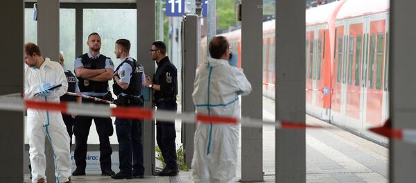Forensic experts of the police stand next to a commuter train standig on a platform of the train station of Grafing near Munich, southern Germany, where a man killed one person and wounded three others in a knife attack on May 10, 2016 - Sputnik International