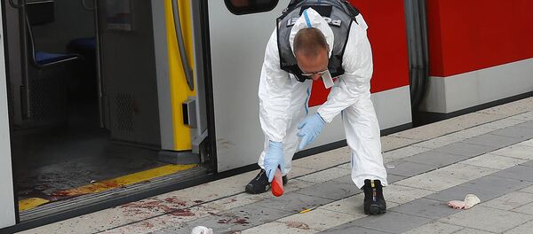 A Police officer investigates the scene of a stabbing at a station in Grafing near Munich, Germany, Tuesday, May 10, 2016 - Sputnik International