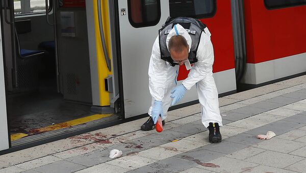 A Police officer investigates the scene of a stabbing at a station in Grafing near Munich, Germany, Tuesday, May 10, 2016 - Sputnik International