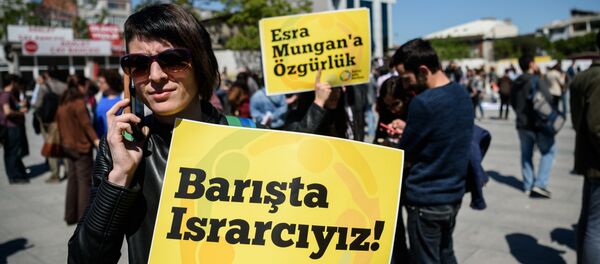 A campaigner holds a placard reading We want peace! during a rally in Istanbul. A campaigner holds a placard reading We want peace! during a rally in Istanbul. - Sputnik International