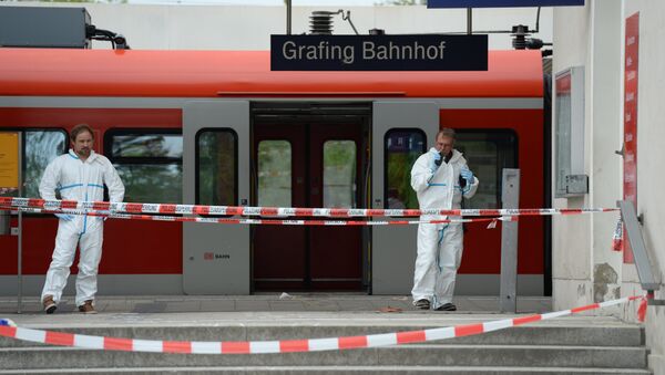 Police officers investigate at the scene of a stabbing at a station in Grafing near Munich, Germany, Tuesday, May 10, 2016 - Sputnik International