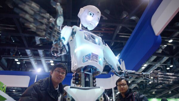 China-science-computer-robot, by Ben DOOLEY This picture taken on November 24, 2015 shows visitors watching a robot (C) demonstration during the World Robot Conference in Beijing - Sputnik International