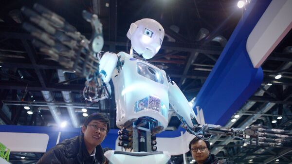 China-science-computer-robot, by Ben DOOLEY This picture taken on November 24, 2015 shows visitors watching a robot (C) demonstration during the World Robot Conference in Beijing - Sputnik International