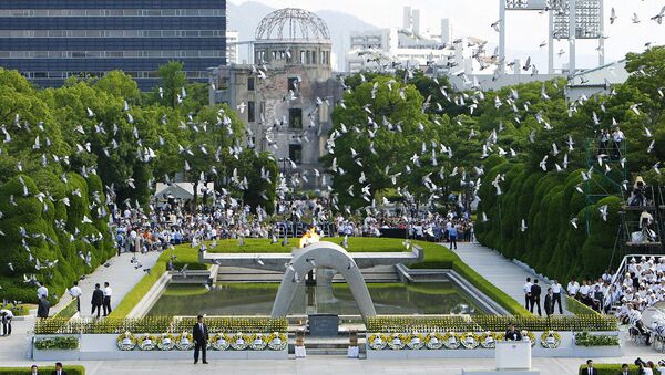 Doves fly over the Peace Memorial Park with a view of the gutted A-bomb dome at a ceremony in Hiroshima, Japan August 6, 2010 - Sputnik International