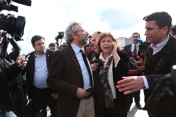 Turkish journalist Can Dundar (2nd L) is seen with his wife Dilek Dundar after an assailant attempted to shoot him outside a courthouse in Istanbul, Turkey May 6, 2016 - Sputnik International