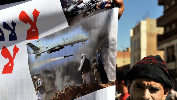 A Yemeni hold up a banner during a protest against US drone attacks on Yemen close to the home of Yemeni President Abdrabuh Mansur Hadi, in the capital Sanaa, on January 28, 2013. - Sputnik International