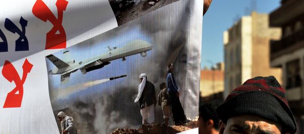 A Yemeni hold up a banner during a protest against US drone attacks on Yemen close to the home of Yemeni President Abdrabuh Mansur Hadi, in the capital Sanaa, on January 28, 2013. - Sputnik International