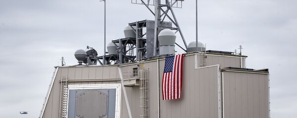 A helicopter flies by the radar building of a missile defense base, in Deveselu, prior to an opening ceremony attended by U.S., NATO and Romanian officials at a base, originally established by the Soviet Union, in Deveselu, Southern Romania, Thursday, May 12, 2016. - Sputnik International