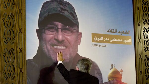 Adnan Badreddine, brother of top Hezbollah commander Mustafa Badreddine, grieves at his brother's picture in a southern suburb of Beirut, Lebanon - Sputnik International