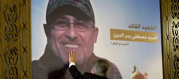 Adnan Badreddine, brother of top Hezbollah commander Mustafa Badreddine, grieves at his brother's picture in a southern suburb of Beirut, Lebanon - Sputnik International