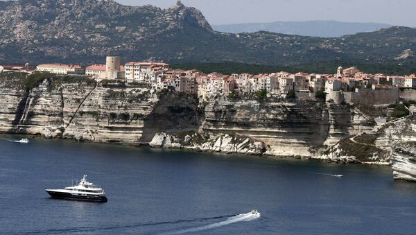 Boats sail off the cliffs of the city of Bonifacio, in the southern French Corsican island - Sputnik International