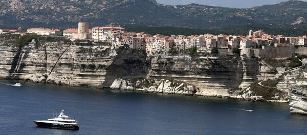 Boats sail off the cliffs of the city of Bonifacio, in the southern French Corsican island Boats sail off the cliffs of the city of Bonifacio, in the southern French Corsican island - Sputnik International