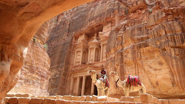 A Jordanian Bedouin sits on a camel in front of the Treasury Building in the ancient city of Petra in Jordan on May 9, 2016 - Sputnik International