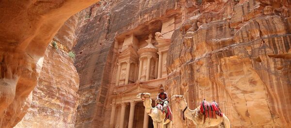 A Jordanian Bedouin sits on a camel in front of the Treasury Building in the ancient city of Petra in Jordan on May 9, 2016 A Jordanian Bedouin sits on a camel in front of the Treasury Building in the ancient city of Petra in Jordan on May 9, 2016 - Sputnik International