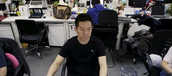 Jia Yueting, co-founder and head of Le Holdings Co Ltd, also known as LeEco and formerly as LeTV, uses a computer on a staff's seat as he poses for a photo (File) Jia Yueting, co-founder and head of Le Holdings Co Ltd, also known as LeEco and formerly as LeTV, uses a computer on a staff's seat as he poses for a photo (File) - Sputnik International